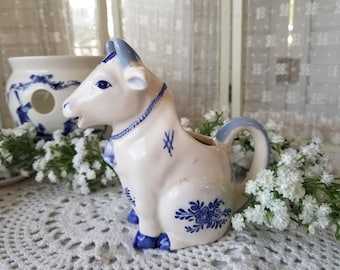 Absolutely charming blue and white vintage farmhouse cow creamer. This painted Dutch cow shaped creamer is the epitome of farmtable decor.