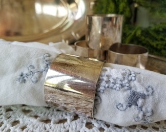 Stylish set of four silver plate napkin rings from Denmark. This quartet of Danish clean lined napkin rings are sleek and simple.