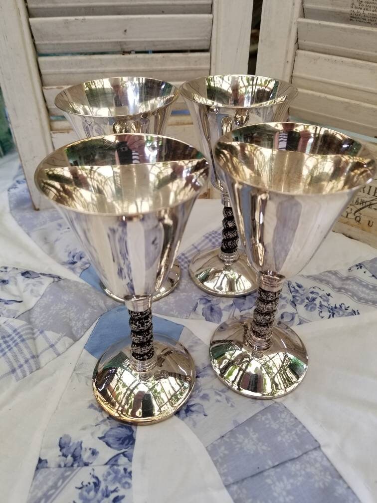 Beautiful and Regal silver plated champagne glasses. This Beautiful and Regal silver plated champagne glasses. This