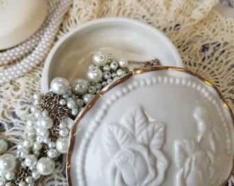 Charming and romantic ivory and gold trinket box. This covered trinket box has a delicious Victorian  or Hollywood Regency appeal.
