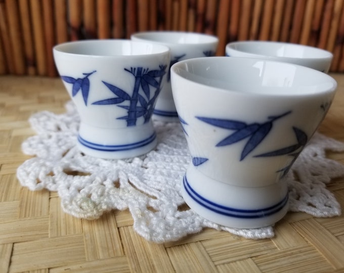 Set of 4 tiny delicate Japanese guimoni sake cups. These 4 diminutive blue and white Japanese sake cups have beautiful bamboo pattern.