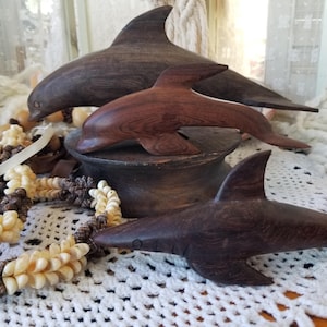 Serene ironwood carving of swimming dolphin or shark. You choose which of these Ironwood aquatic creatures to Adorn your beach house.