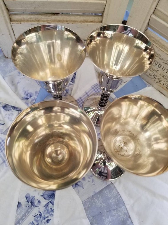 Beautiful and Regal silver plated champagne glasses. This Beautiful and Regal silver plated champagne glasses. This