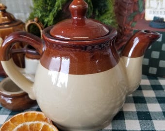 Cozy little brown toned teapot. This Charming mid-century drip Ware teapot is the perfect size for a single or double serving of tea.