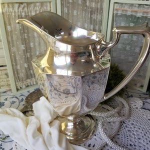 Beautiful elegant Fisher silver plated water pitcher. This ornate silver water pitcher is from an era of Elegance and fine dining.