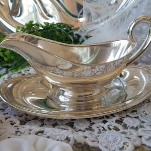 Gorgeous and gleaming Gorham silver plated sauce boat. This elegant silver plated gravy boat has an attached plate beneath. image 1