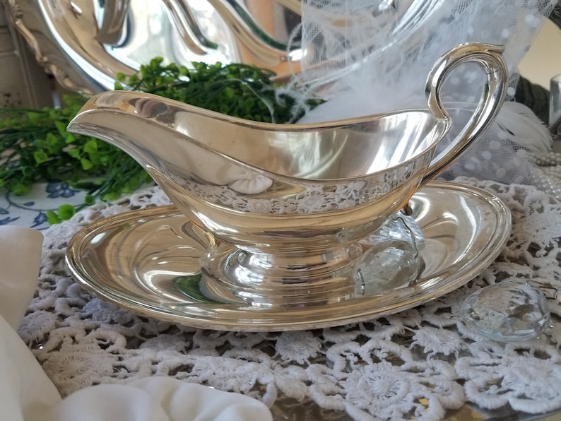 Gorgeous and gleaming Gorham silver plated sauce boat. This elegant silver plated gravy boat has an attached plate beneath. image 1