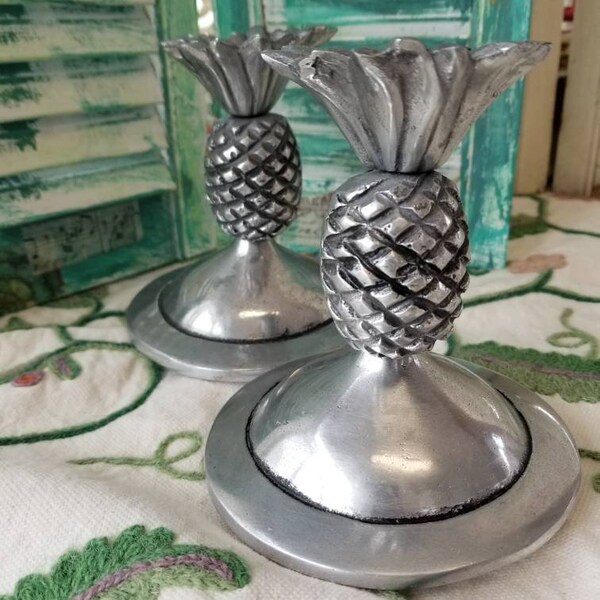 Spectacular pair of heavy pewter pineapple canister covers. These two fabulous heavy pewter jar or canister lids have a a tropical feel.