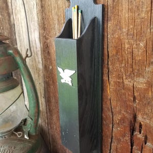 Charming mid century fireplace match stick holder. This long match box, with American Eagle, is crafted from heavy black resin.
