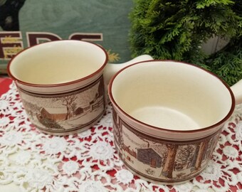 A fun and nostalgic pair of Watkins Almanac December 1904 handled soup bowls. These two bowls feature New England Christmas winter images.