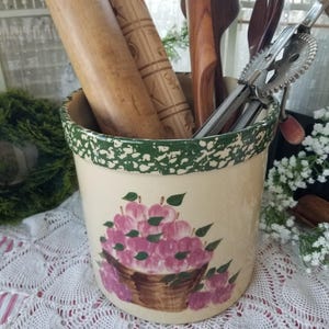 May include: A set of three ceramic mugs with a speckled, matte finish. The mugs are in shades of cream, light gray, and dark gray. Each mug has a simple, minimalist design and a rounded handle.