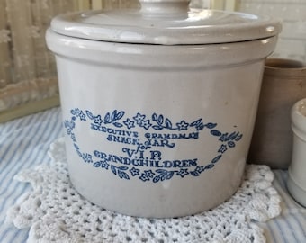 May include: A white ceramic jar with a blue and white floral design. The jar has a lid and says "Executive Grandma's Snack Jar V.I.P. Grandchildren".