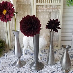 Charming selection of vintage pewter bud vases for your garden blooms. These four rustic pewter Budvase very in size and age.
