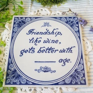 Beautiful folk art blue and white friendship theme ceramic tile from Holland. This gorgeous vintage delft blauw tile is a real keepsake.