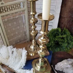 Pair of gleaming 11 inch brass candlesticks. These charming brass candlesticks could adorn any farm table or mantel.