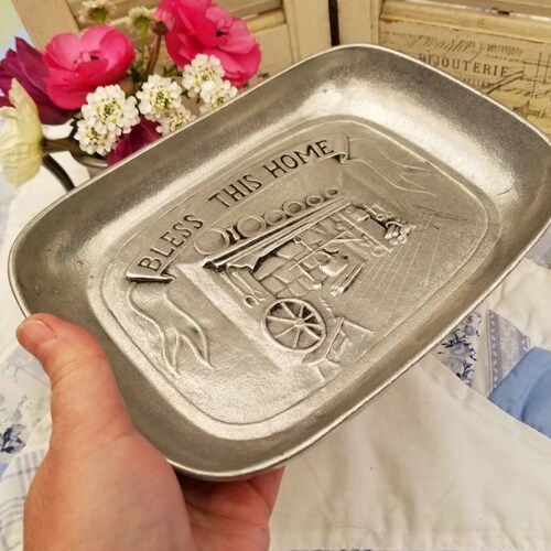 Gorgeous pewter farmhouse tray. Depicted on this sweet tray is a colonial era fireplace with a banner overhead reading 'Bless this Home'.