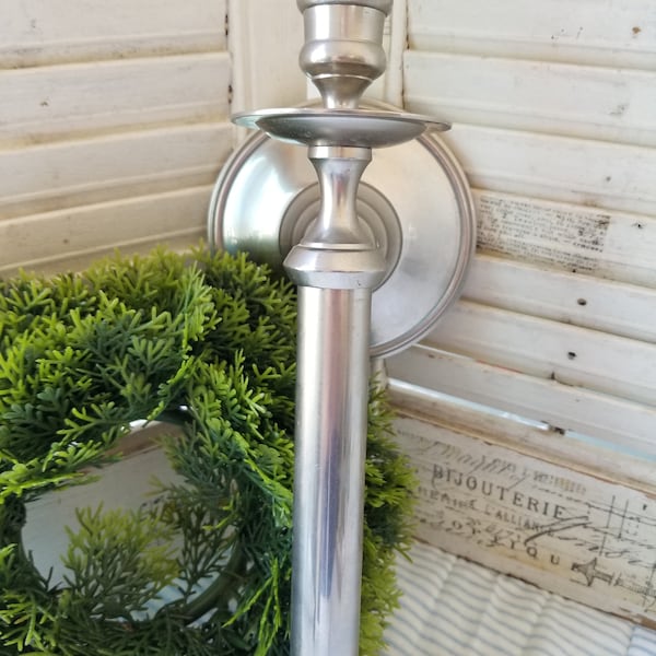 Regal elegant silvered brass candle wall sconce. This heavy streamlined silver wall sconce will look beautiful in your entryway or Portico.