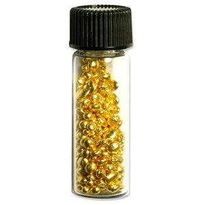 May include: A small glass bottle with a black lid filled with gold nuggets.