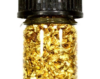 May include: A small glass jar with a black lid filled with gold flakes.
