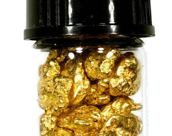 May include: A small glass vial with a black lid filled with gold nuggets. The nuggets are irregular in shape and have a shiny, metallic finish.