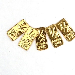 5 lingotes de oro de 24 k de 1/2 grano y pureza de 0,9999. En tarjeta de certificación.