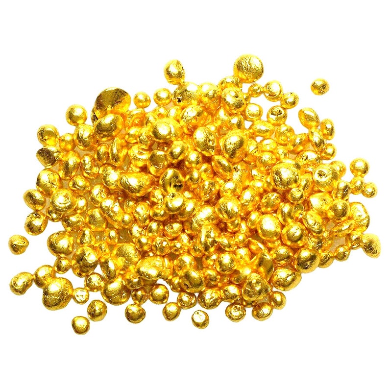 May include: A pile of shiny, golden nuggets, likely gold, on a white background.