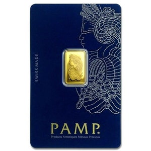 May include: A gold bar with a woman's profile on it, in a blue card with the text "PAMP. Produits Artistiques Metaux Precieux" and "SWISS MADE".