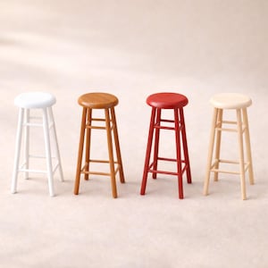 May include: Four wooden bar stools in a row, each with a round seat and a footrest. The stools are painted in white, brown, red, and natural wood tones. The stools are approximately 24 inches tall.