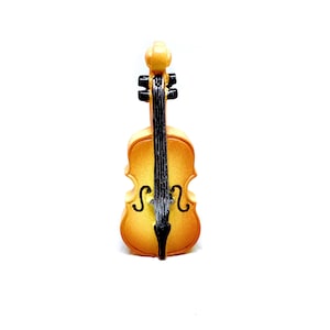 May include: A small, wooden, brown cello with black strings and tuning pegs.