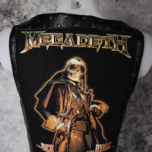 May include: Black leather vest with a Megadeth logo and a graphic of a skeleton figure with the text "The Sick, The Dying... And The Dead!"