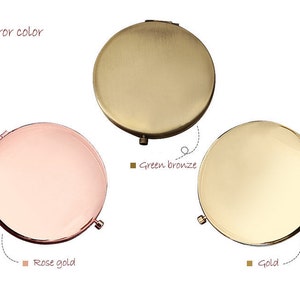 May include: Three round compact mirrors with different coloured finishes: rose gold, green bronze, and gold.  Mirror colour is written below each mirror.