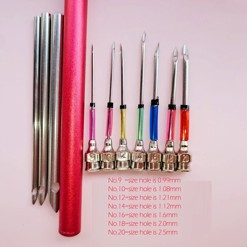 May include: A set of 8 metal tools with different sized holes, ranging from 0.99mm to 2.5mm. The tools are color-coded and labeled with their corresponding size. The tools are arranged on a pink surface.