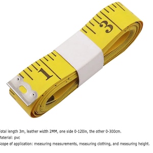 May include: A yellow measuring tape with black markings and a silver metal end. The tape is rolled up and secured with a white label. The tape measures up to 120 inches or 300 centimeters.