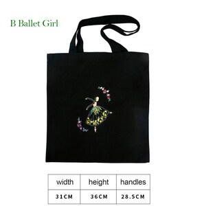 May include: Black canvas tote bag with an embroidered image of a ballerina in a yellow and blue dress. The bag has black handles and measures 31 inches wide, 36 inches high, and 28.5 inches in handle length.