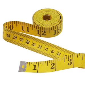 May include: A yellow measuring tape with black markings and numbers. The tape is rolled up and partially unrolled, showing numbers from 1 to 23.