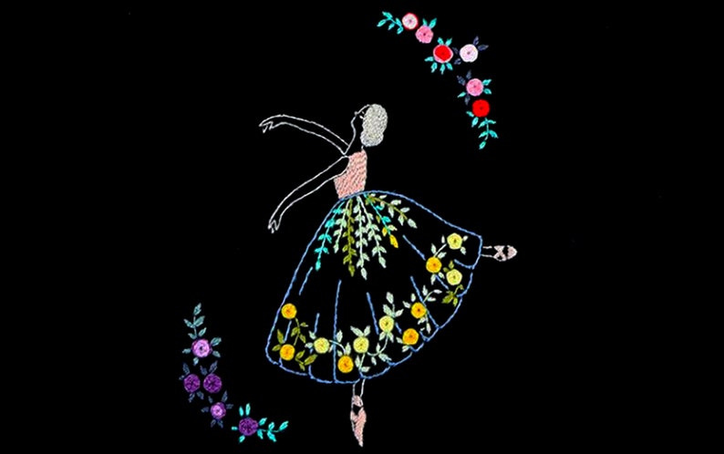 May include: Embroidered design of a ballerina in a blue dress with yellow and green floral details. The ballerina is surrounded by a wreath of pink and red flowers.