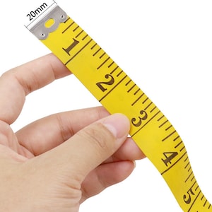 May include: A yellow measuring tape with black markings and a silver metal end. The tape is marked with numbers from 1 to 5.
