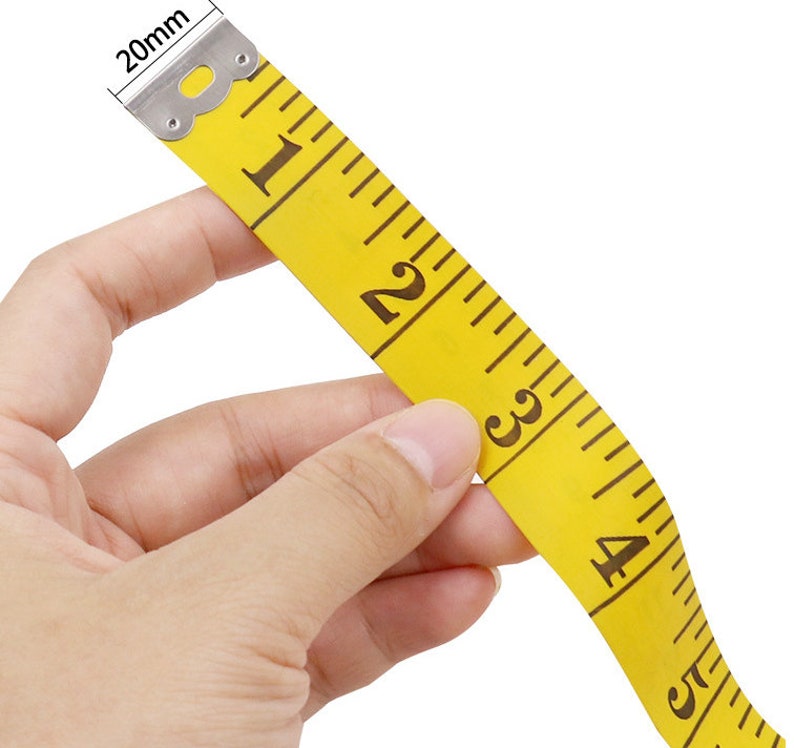 May include: A yellow measuring tape with black markings and a silver metal end. The tape is marked with numbers from 1 to 5.