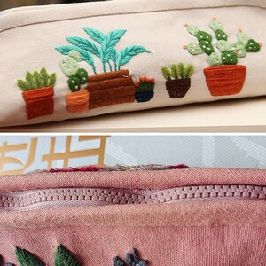 May include: A beige canvas zippered pouch with a colorful embroidered design of potted plants. The pouch has a pink zipper and a pink lining.