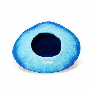 May include: A blue and light blue felt pet bed shaped like a dome with a round opening. The bed has a label that reads "Everest Pet Cave".