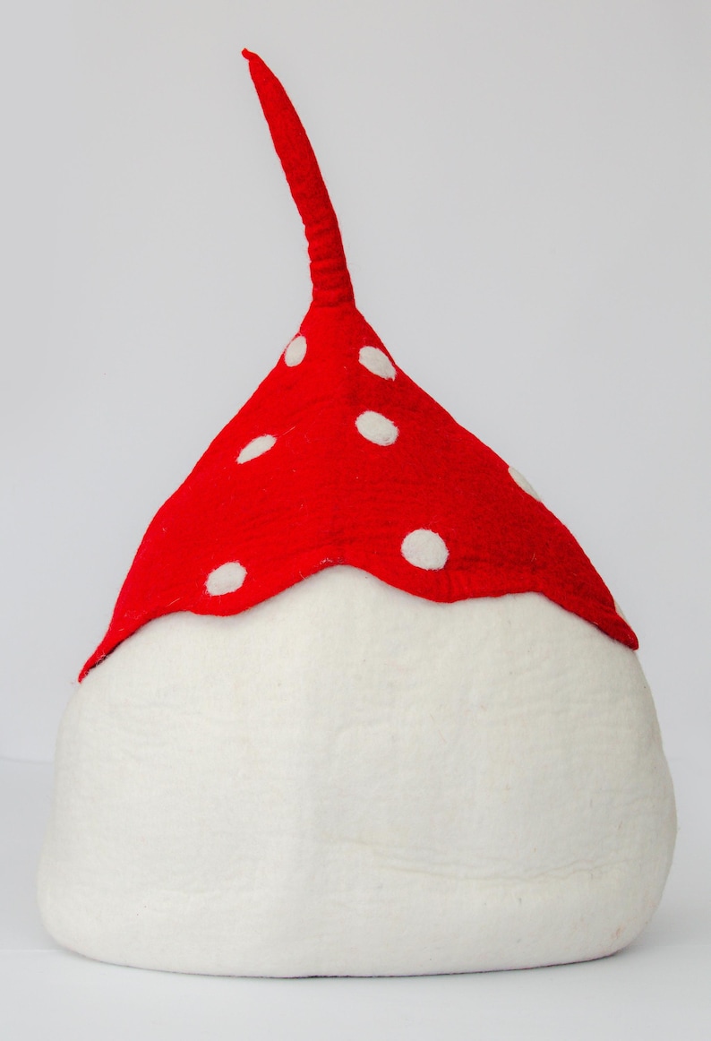 May include: A whimsical mushroom-shaped hat with a white base and a vibrant red cap adorned with white polka dots. The hat features a long, red, stem-like extension. This playful accessory is perfect for costume parties or themed events.