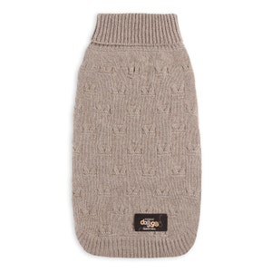May include: A beige knitted dog sweater with a crown pattern and a small brown label that says "Everest Doggo Sweaters".