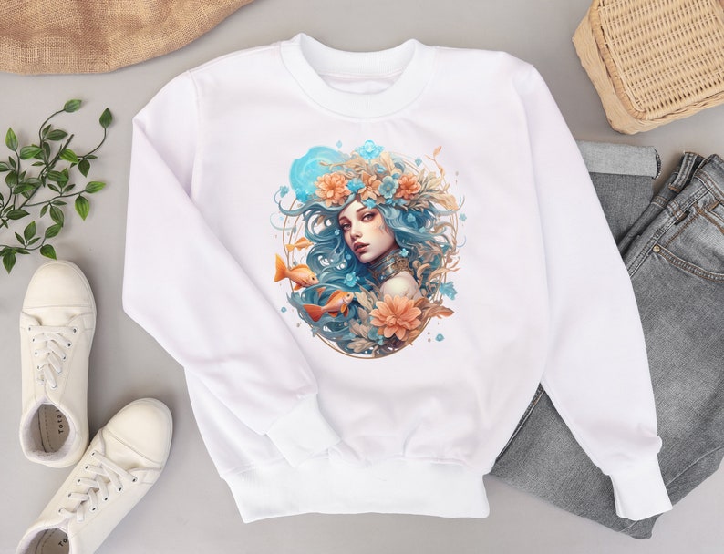 May include: White sweatshirt with a colorful illustration of a woman with long blue hair wearing a floral crown and surrounded by flowers and fish.