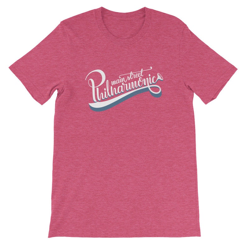 May include: A heather pink t-shirt with a white and blue graphic that says "main street philharmonic" in a retro font.