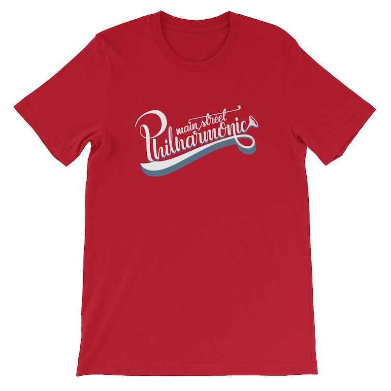 May include: Red short-sleeved t-shirt with a white graphic that says "main street philharmonics" in a stylized font.