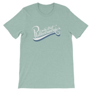 May include: A light blue t-shirt with a white graphic that says "Main Street Philharmonic" in a stylized font with a musical note.