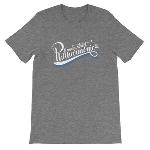 May include: Gray t-shirt with a white graphic that says "Main Street Philharmonic" in a stylized font with a blue trumpet graphic.
