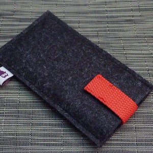 May include: A black felt phone case with a red fabric strap and a small purple owl logo.