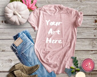 Download Free Bella Canvas 3001 Peach Shirt Mockup | Fall Shirt Mockup for Heather Peach T-Shirt | Peach Shirt Flat Lay with Pumpkin on Barn Wood Floor PSD Template