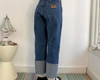Vintage faded medium wash loose fit western jeans by Wrangler, fits W28-30